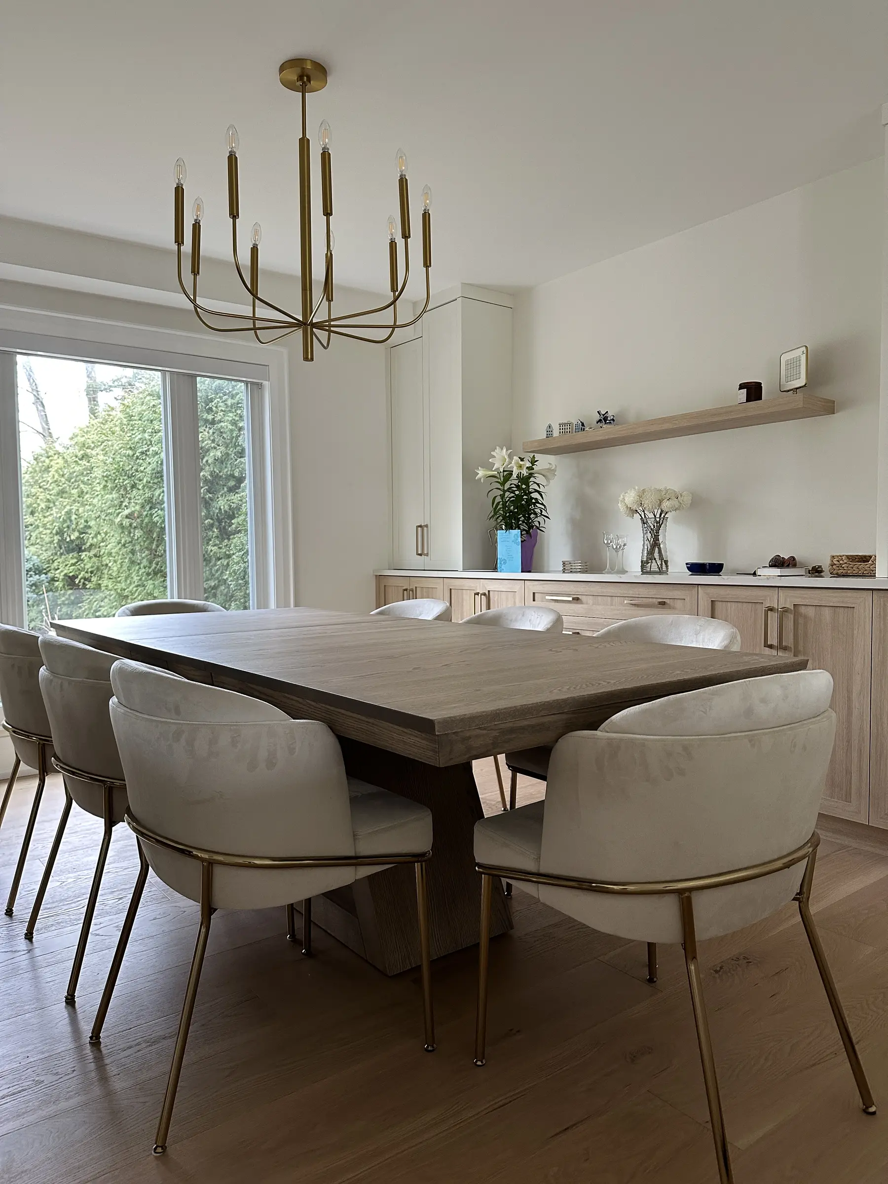 Modern custom dining table surrounded by upholstered barrel chairs