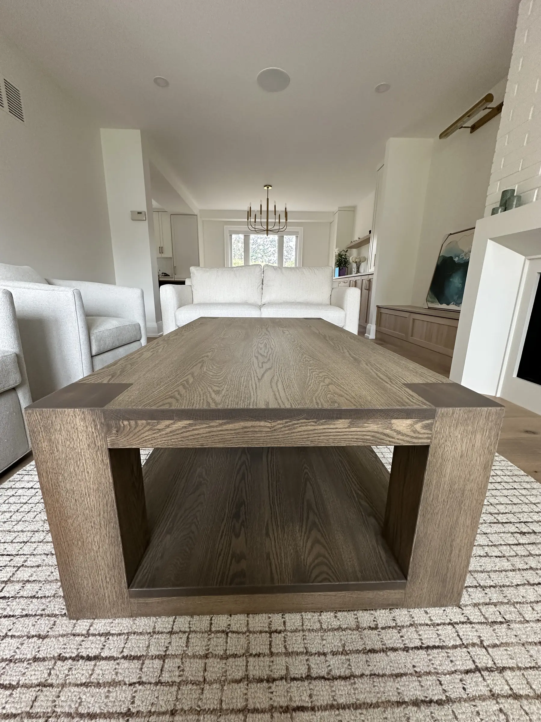 Modern trestle-style solid wood dining table in a bright living space