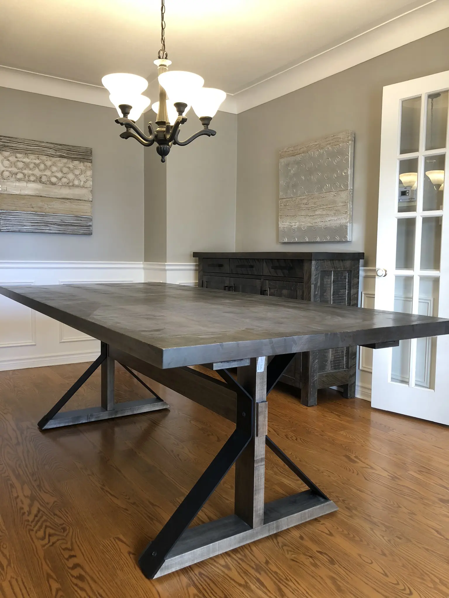 Moorhouse custom dining table with modern metal base and light wood top