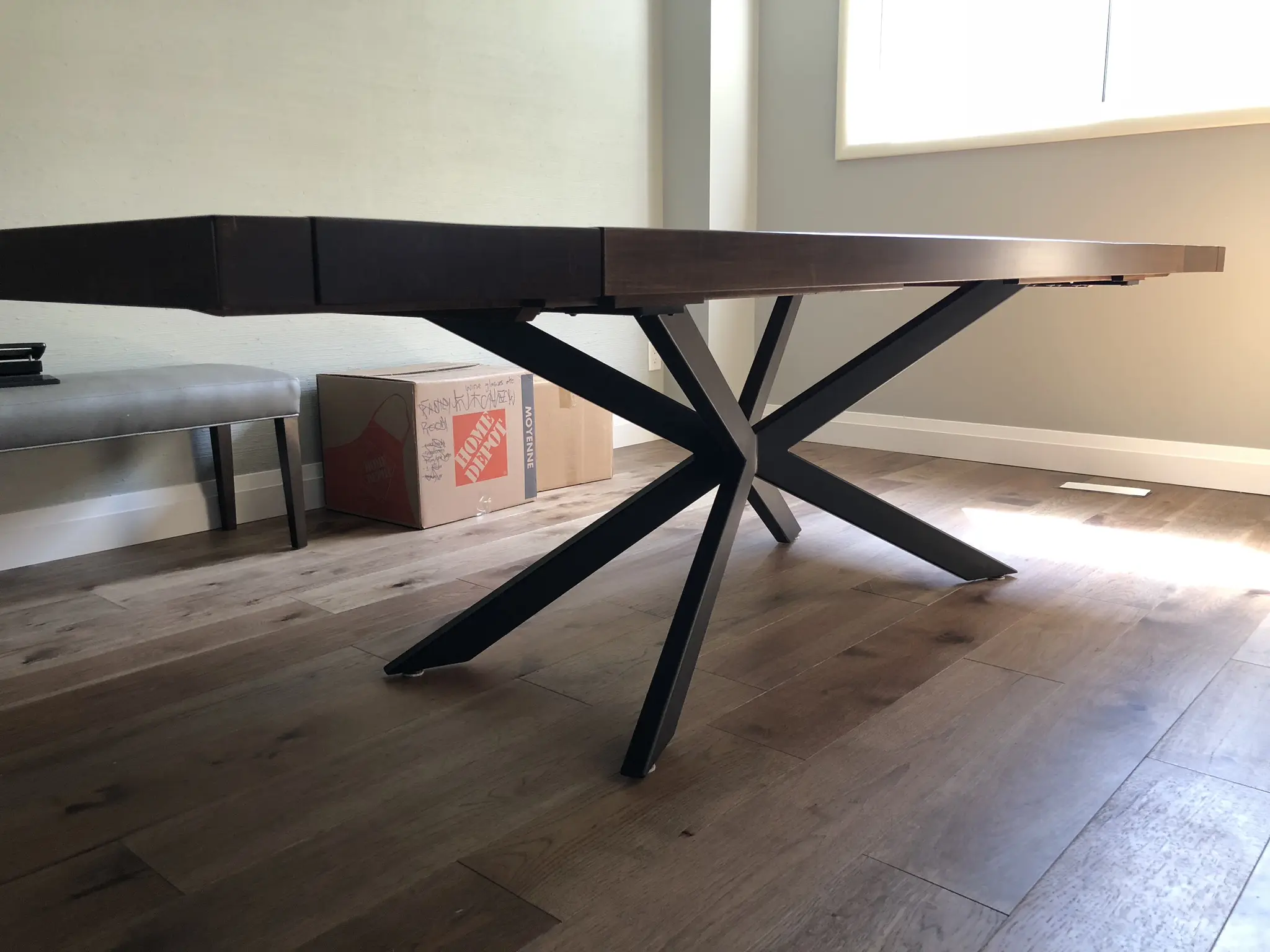 Norseman solid wood dining table with sculptural black metal base