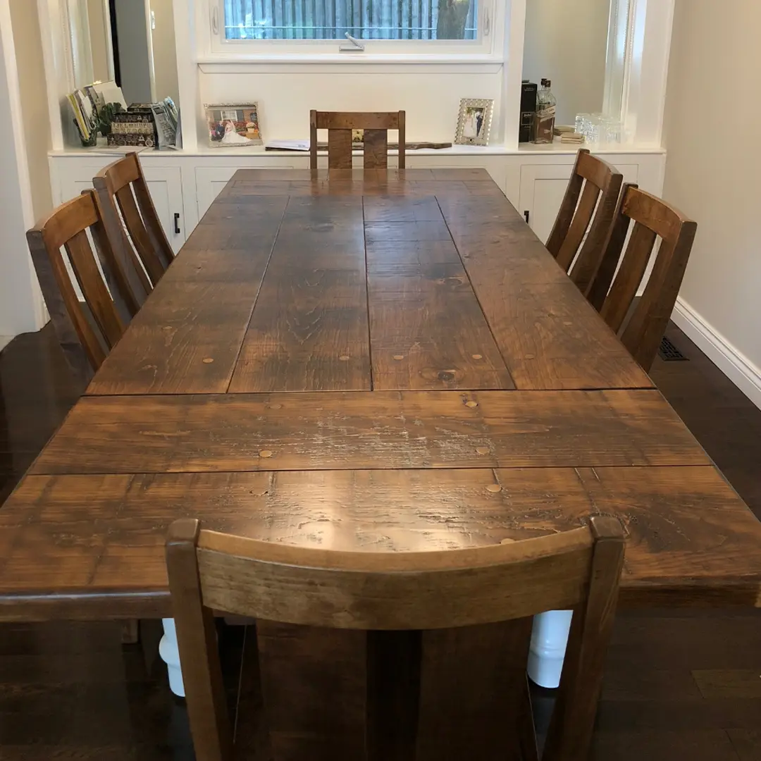 Long two-tone custom solid wood dining table with matching chairs